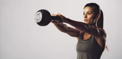 Young fitness female exercise with kettle bell.